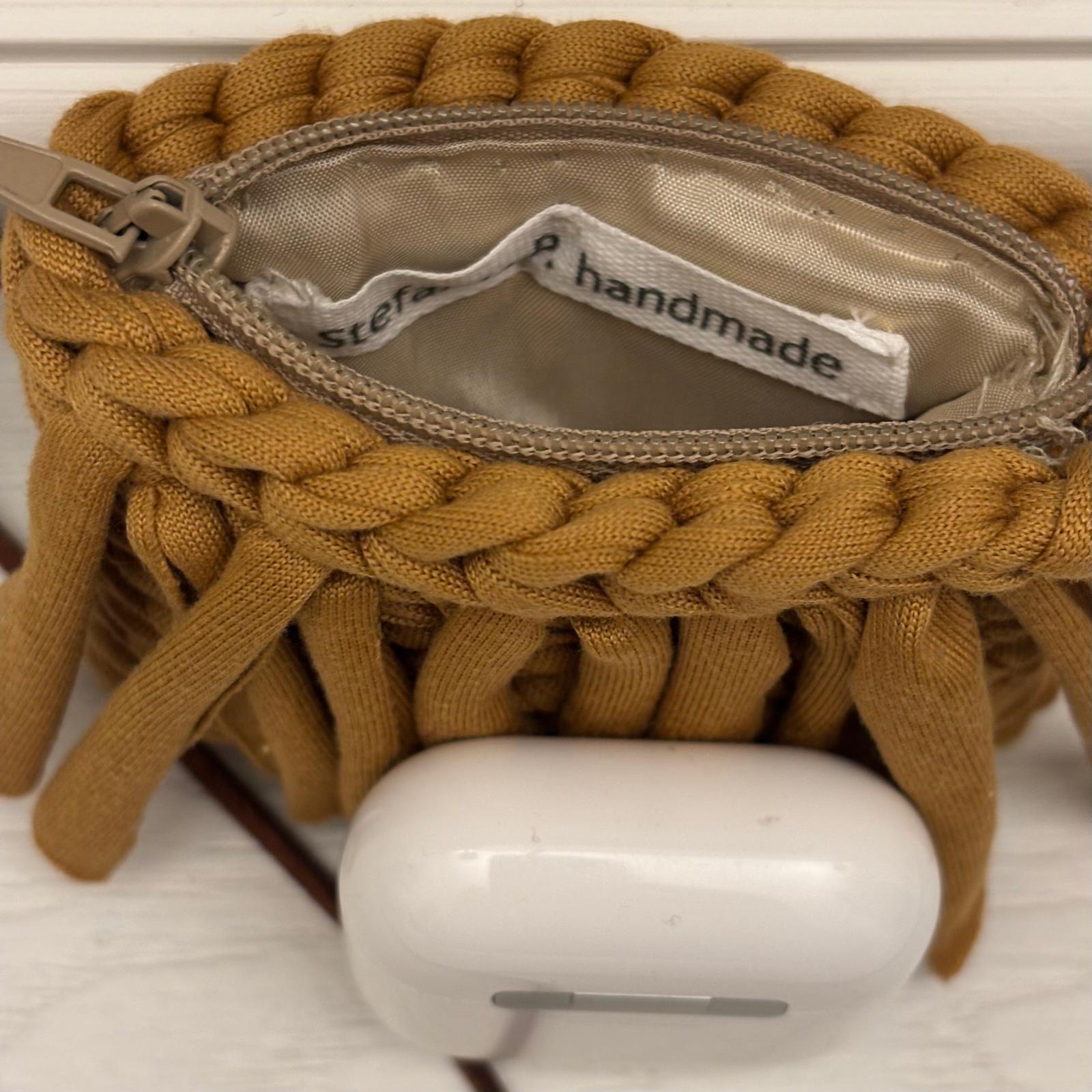 Dettaglio porta AirPods tracolla cuoio e zip